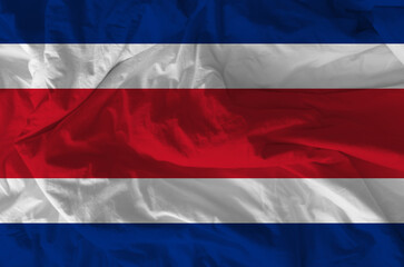 Stylized image of Costa Rica flag with crumpled paper texture and halftone effect. Statehood concept.