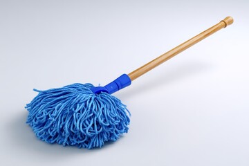 Blue string mop with wooden handle on white background for cleaning concept.
