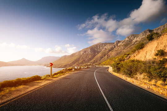Scenic road along Ocean and Mountains at sunset. Chapman&rsquo;s Peak Drive.