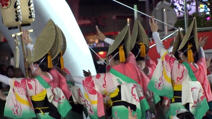 TOKYO, JAPAN - AUG 2025 : Slow motion shot of Awa Odori dance festival in Koenji. Powerful and energetic dance and music. Traditional Japanese summer event in Tokyo. Close up shot of dancer.