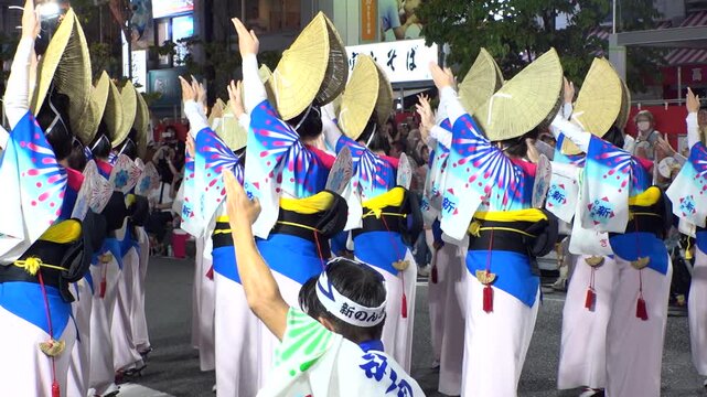TOKYO, JAPAN - AUG 2025 : Slow motion shot of Awa Odori dance festival in Koenji. Powerful and energetic dance and music. Traditional Japanese summer event in Tokyo. Close up shot of dancer.
