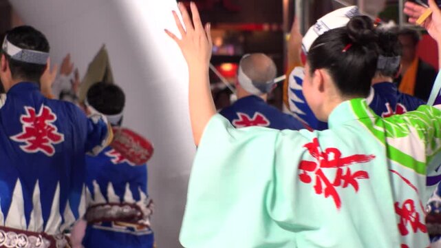 TOKYO, JAPAN - AUG 2025 : Slow motion shot of Awa Odori dance festival in Koenji. Powerful and energetic dance and music. Traditional Japanese summer event in Tokyo. Close up shot of dancer.