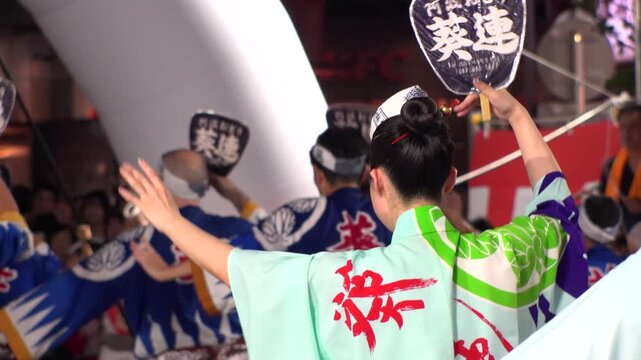 TOKYO, JAPAN - AUG 2025 : Slow motion shot of Awa Odori dance festival in Koenji. Powerful and energetic dance and music. Traditional Japanese summer event in Tokyo. Close up shot of dancer.