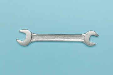 Silver Wrench on Light Blue Background: Essential Tool for DIY and Professional Repairs