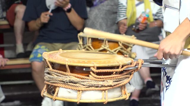TOKYO, JAPAN - AUG 2025 : Slow motion shot of Awa Odori dance festival in Koenji. Powerful and energetic dance and music. Traditional Japanese summer event in Tokyo. Close up shot of drum.