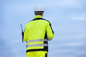 Petrochemical or refinery industry engineer working on laptop computer inspection petroleum oil refinery plant construction site. Engineering technician maintaining energy power gas system.