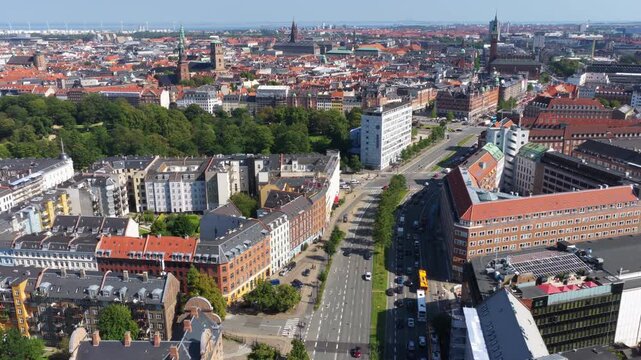 Aerial drone view of central Copenhagen, Denmark featuring Orstedsparken, historic churches, and orange rooftops