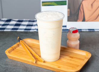 Duoduo Lemon Smoothie with a Probiotic Yogurt Drink in plastic cup on wooden tray side view of hong kong Drink