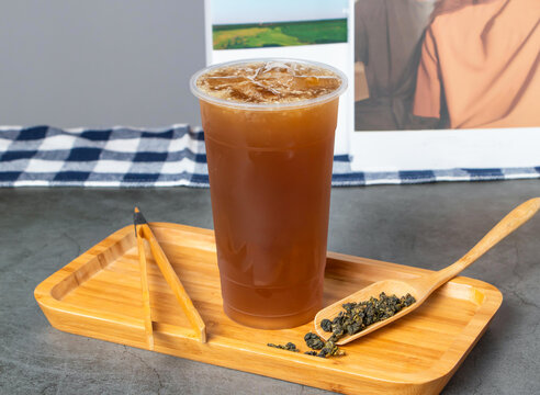 Iced Winter Melon Lemon Tea in plastic cup on wooden tray side view of hong kong Drink