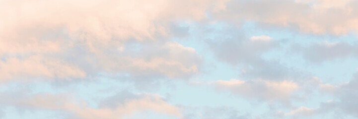 Beautiful sunset sky background with clouds. Scenic cloudscape. Wide panoramic background for design.