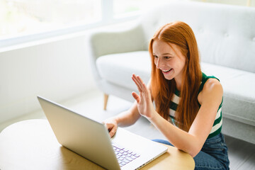 Fototapeta premium Portrait beautiful young woman at home on the living room using laptop