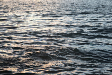 Calm bay water at sunset with soft reflections