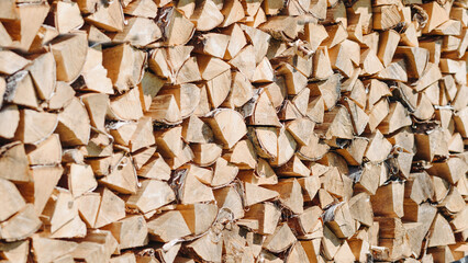 pile of chopped and stacked firewood for fire and heating, background