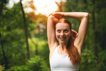 Obraz premium Happy athletic woman running while exercising in nature. Copy space.