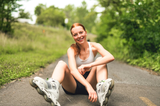 Happy athletic woman running while exercising in nature with roller