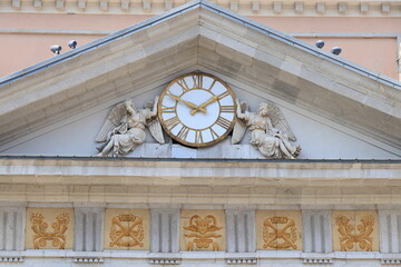 Pediment with Two Angels Holding a Clock on the Facade of the Chamber of Commerce Building in Trieste, Italy