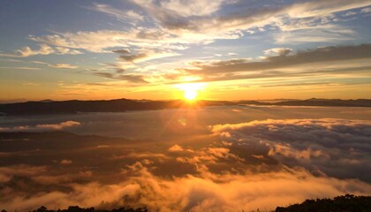 Golden sunrise over a misty mountain range