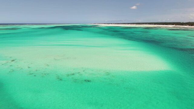 Shallow Sandbanks and Vibrant Aquamarine Tides Along Zanzibar's Shore, Tanzania