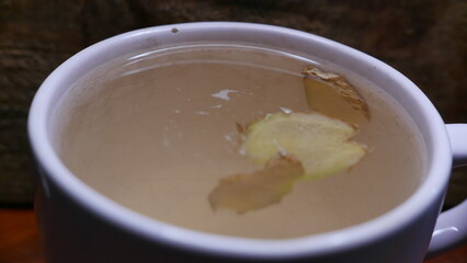 Ginger tea on the table. A cup of hot tea. A large cup of ginger tea. A tea mug, close-up shot.