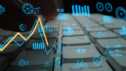 A close-up view of a computer keyboard with digital analytics graphics displaying growth metrics and data visualizations, highlighting modern data analysis tools. Xenic