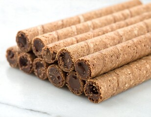 Chocolate wafer sticks stacked on marble