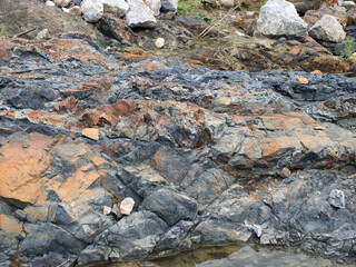 Fototapeta premium Black rocks from drilling in rivers and streams.