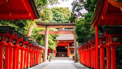 Red torii gates and lanterns line path to Japanese shrine