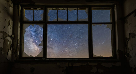 Fototapeta premium Abandoned room view: Milky Way through shattered glass windows at twilight