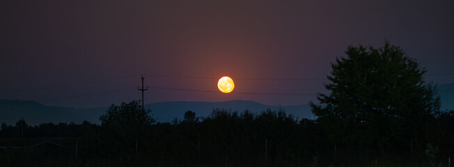 Moonrise over the foothills of the Carpathians in Transylvania, Romania