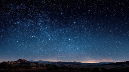 Naklejka premium Starry night sky over mountains in rural landscape