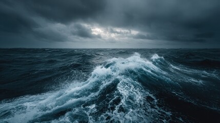 Fototapeta premium Rolling waves clash with dark clouds over an expansive ocean at twilight