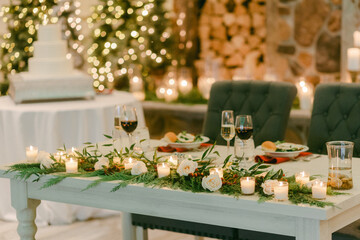 Elegant wedding reception setting with floral decor, candlelight, and gourmet meal in a cozy indoor venue