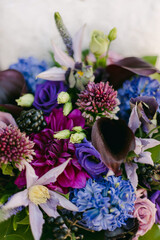 Vibrant floral arrangement featuring a variety of colorful blooms and greenery in a detailed composition