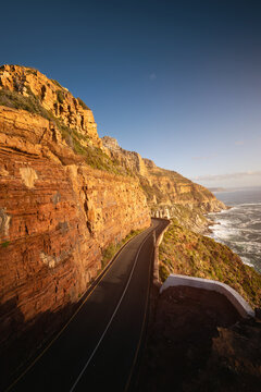 Scenic road along Ocean and Mountains at sunset. Chapman&rsquo;s Peak Drive.