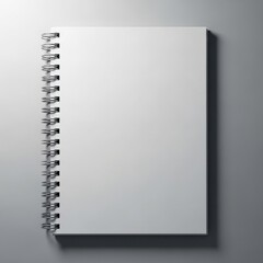 A blank white spiral bound notebook with a metal coil binding is presented isolated on white background