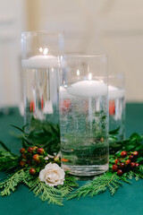 Elegant table decor with floating candles and greenery creates a serene atmosphere for a special event celebration
