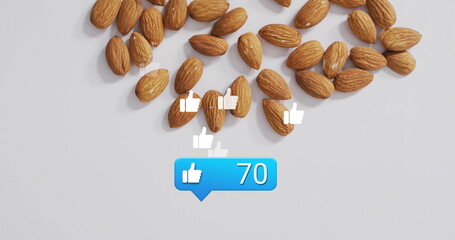 Showcasing unroasted almonds resting on studio desk, floating thumbs up icons and blue like bubble
