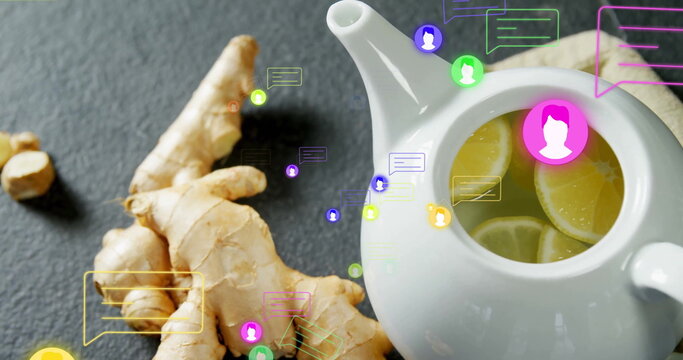 Fototapeta Displaying white ceramic teapot brewing lemon-ginger tea on tabletop with chat bubbles, copy space