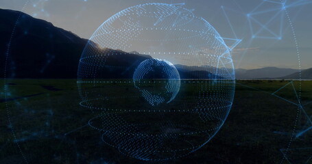 Obraz premium Floating digital holographic globe glowing above grassy plain at sunset, with network grid overlay