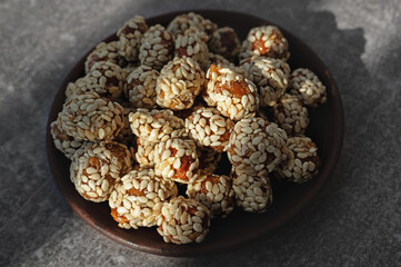 Sweet snack. Nuts coated with sugar and sesame seeds. Hazelnuts, Peanuts, Sunflower seeds. Close Up.