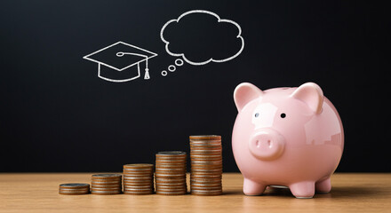 Saving for education dream, graduation cap thought bubble, piggy bank, and growing coin stacks on desk
