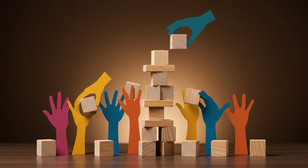 Teamwork building success with colorful hands stacking wooden blocks in a collaborative effort