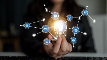 Explore the fusion of innovation and technology illustrated by a light bulb in a modern workspace, symbolizing creativity and connectivity in the digital world. Tessel