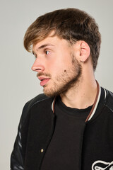 Obraz premium Close-up portrait of young Caucasian man with earring in studio with white background