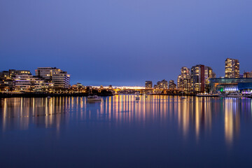 Fototapeta premium Vancouver, Canada - April 09, 2017: The city of Vancouver illuminated at night with the famous BC stadium.