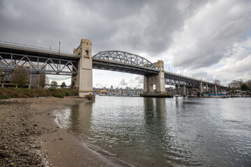 Vancouver, Canada - April 11, 2017: Burrard Street Bridge, art Deco-style steel bridge from the 1930s on four tall pillars overlooking the docks and Granville Island.