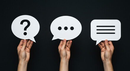 Hands holding speech bubbles question ideas message communication chat support concepts on black background