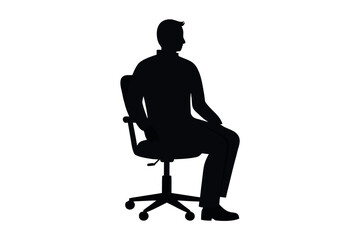 Silhouette of a person seated in an office chair during late afternoon
