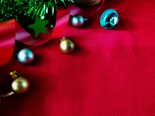 Festive decorations are arranged on a red textured fabric