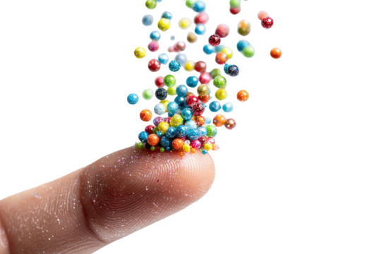 Colorful, small, spherical candies or sprinkles are erupting from a fingertip
